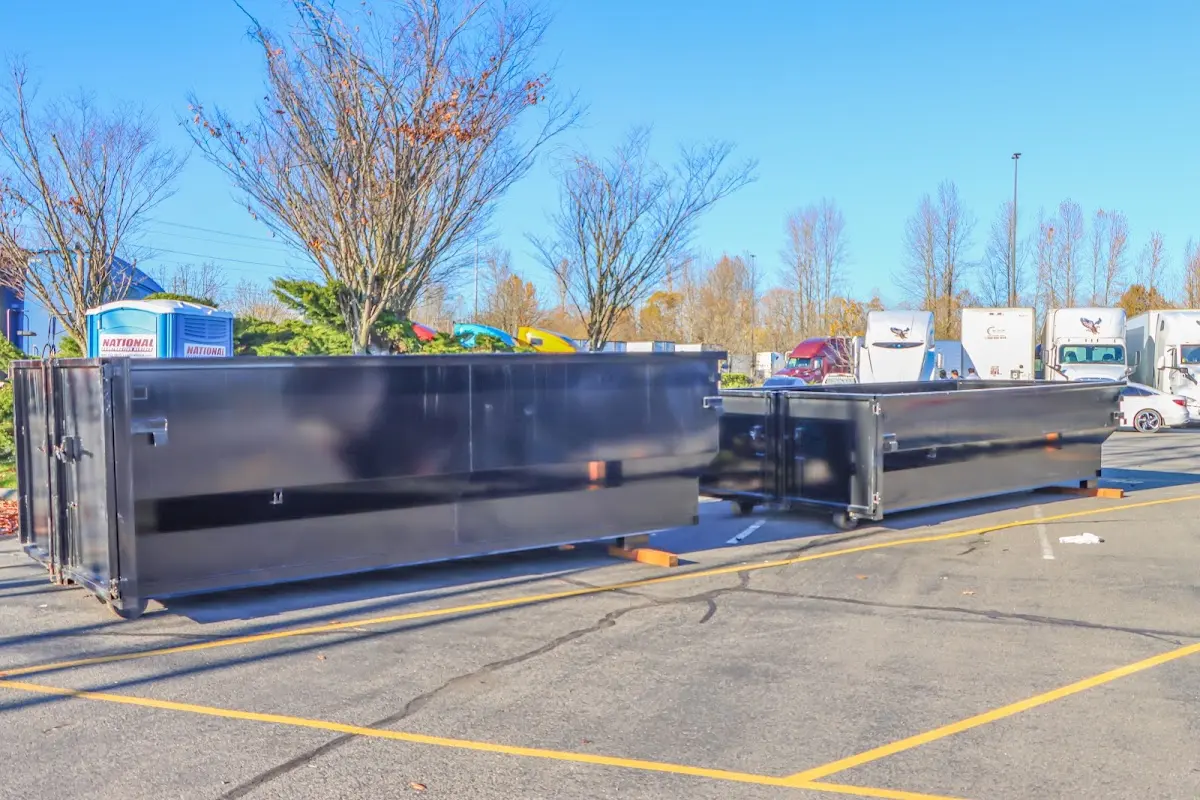 Professional dumpster rental service with roll-off container on residential driveway in Newbury